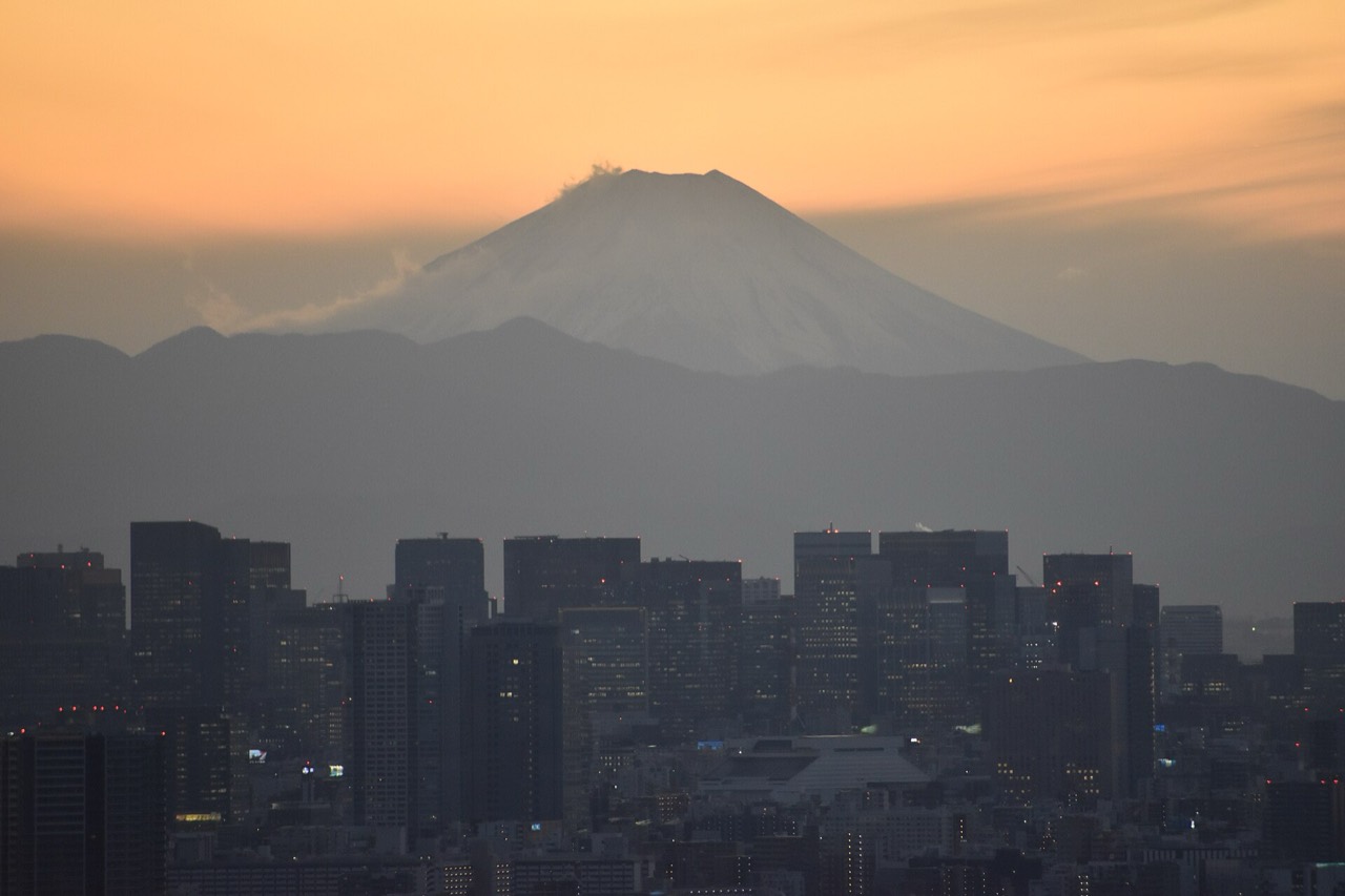 Mount Fuji rising behind the city skyline