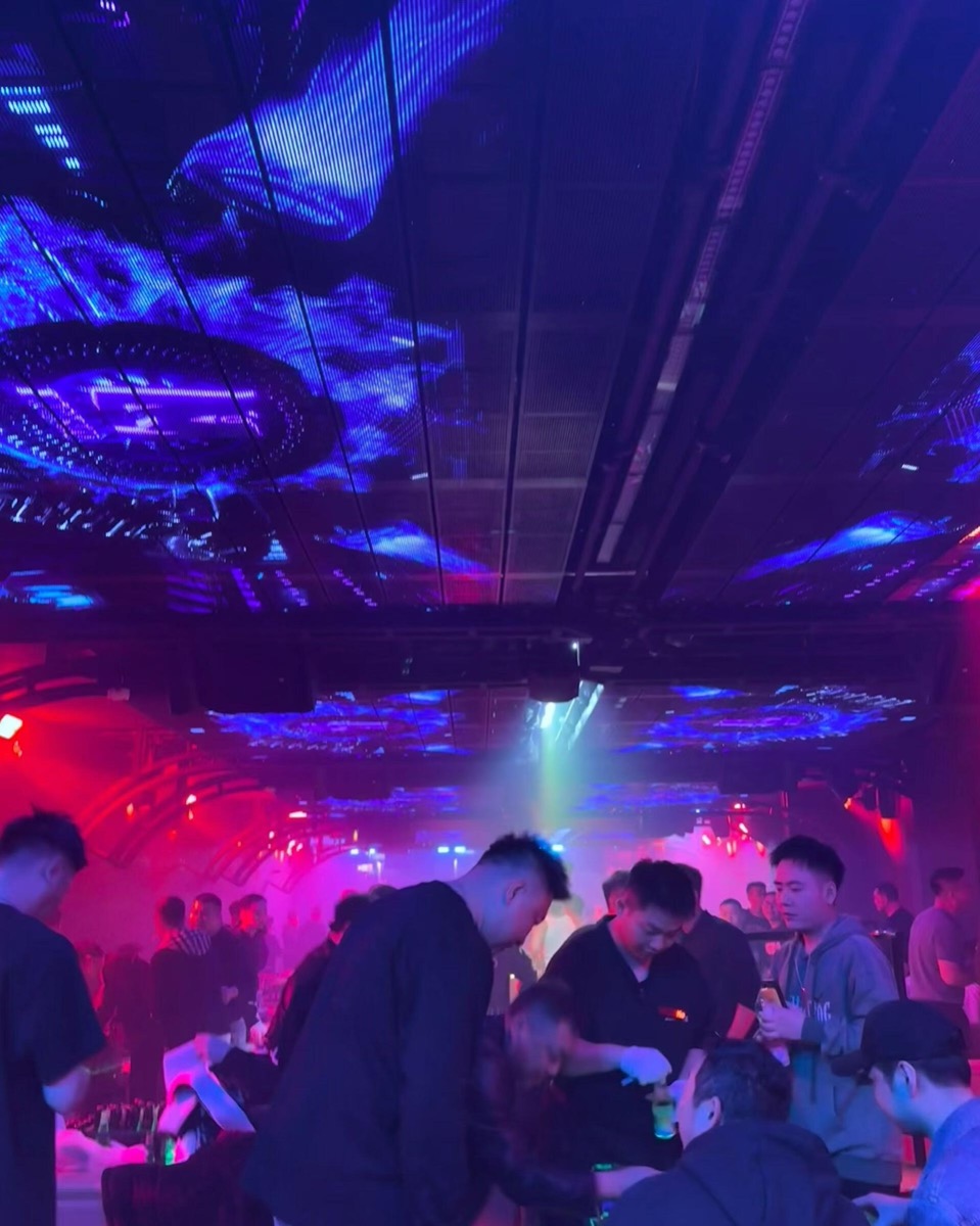 Professional muscle dancers performing at Monster House, a gay club in Chengdu