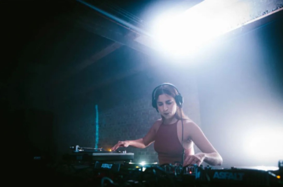 DJ playing in moody light at Potent, Shanghai