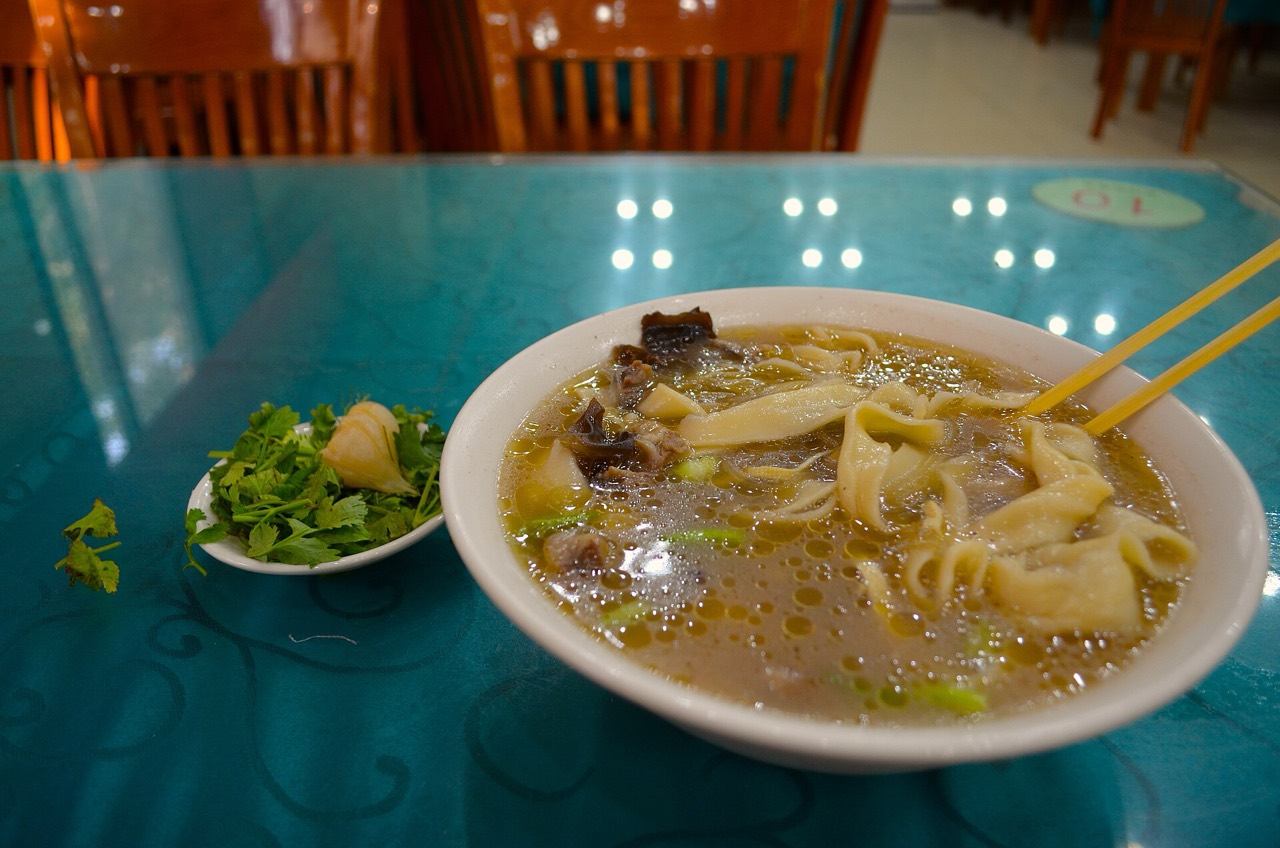 A bowl of Henan huimian — hand-pulled braised noodles in lamb broth